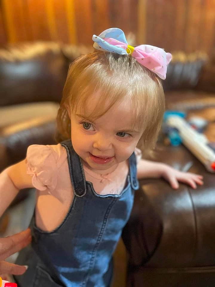 Georgia is registered to the contest to win money with this photo: arm, baby_toddler_clothing, blond, child, event, eye, facial_expression, fun, hairstyle, hand, happy, headpiece, iris, jewellery, leisure, people, person, sitting, skin, smile