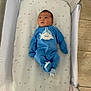 Dianelys is registered to the contest to win money with this photo: baby, infant, crib, blue_onesie, shark_design, mattress, moon_pattern, star_pattern, mesh_sides, floor_tiles, sleeping_area, cute, child, newborn, footed_pajamas, indoor, resting, young_baby, baby_clothing, peaceful
