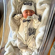 Dianelys joined the competition — help win amazing prizes! newborn, baby, infant, blanket, bassinet, pacifier, hat, clothing, sleeping, indoors, hospital, soft_fabric, white, cute, face, person, newborn_clothes, cozy, resting, wrapped