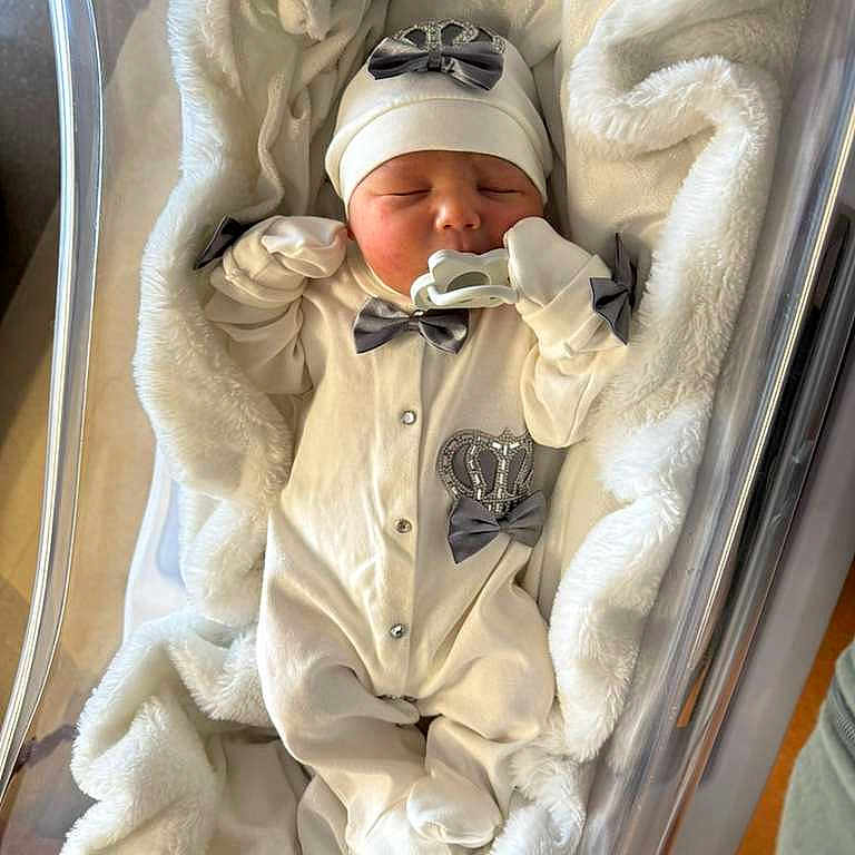 Dianelys joined the competition — help win amazing prizes! baby, bassinet, blanket, clothing, cozy, cute, face, hat, hospital, indoors, infant, newborn, newborn_clothes, pacifier, person, resting, sleeping, soft_fabric, white, wrapped