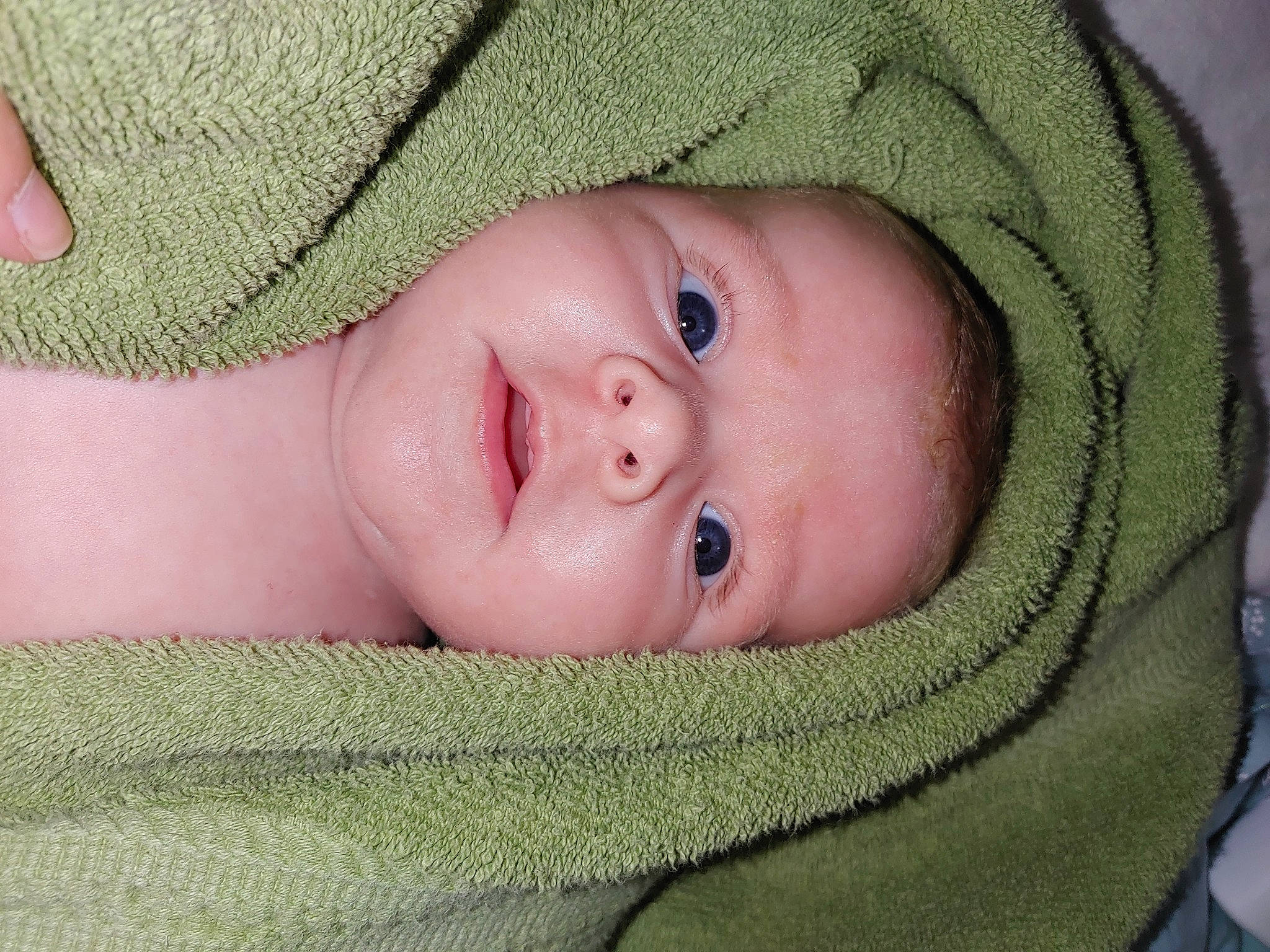 Oakley is registered to the contest to win money with this photo: baby, cheek, child, chin, comfort, eye, eyebrow, face, facial_expression, head, headgear, iris, lip, mammal, mouth, nose, person, skin, smile, textile