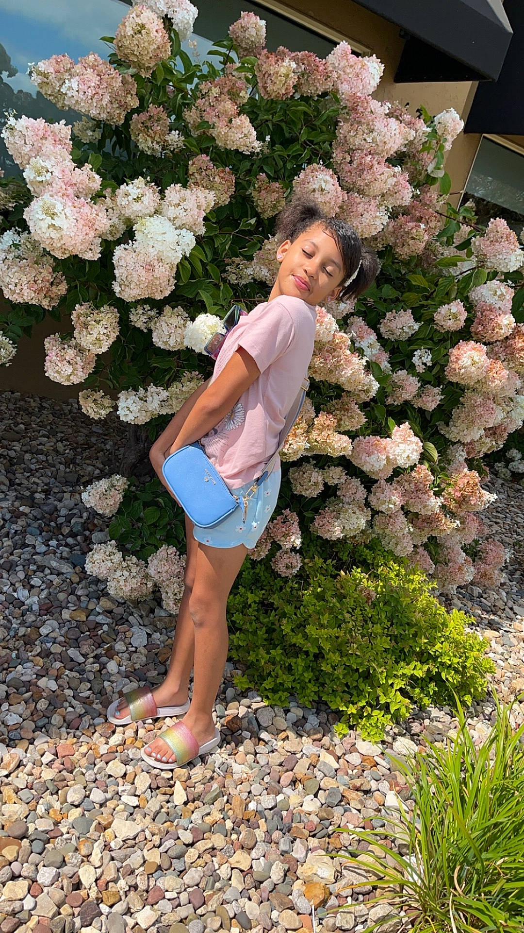 Khileé is registered to the contest to win money with this photo: blouse, child, clothing, face, female, flower, flowerarrangement, flowerbouquet, geranium, girl, head, person, photography, plant, portrait, pottedplant, rock, shorts, slate, vegetation