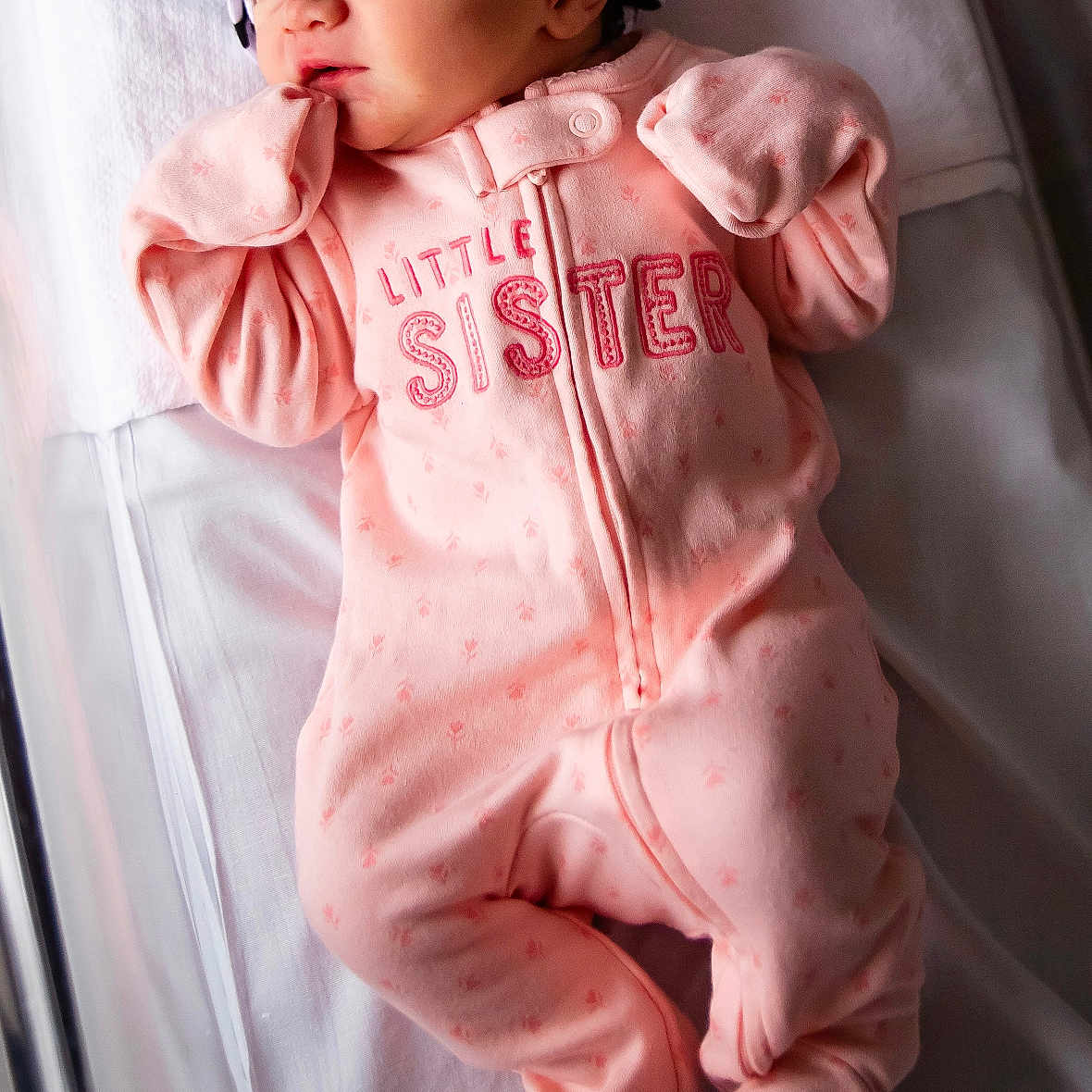 Bella is registered to the contest to win money with this photo: baby, baby_clothes, baby_girl, blanket, child, crib, cute, headband, indoor, infant, newborn, onesie, peaceful, pink_clothing, portrait, resting, sleep, sleeping, soft_lighting, striped_headband