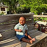 Jeremiah joined the competition — help win amazing prizes! toddler, child, smiling, bench, wooden, outdoor, sunlight, greenery, garden, plants, shirt, shorts, barefoot, nature, daytime, portrait, happy, person, casual, seat
