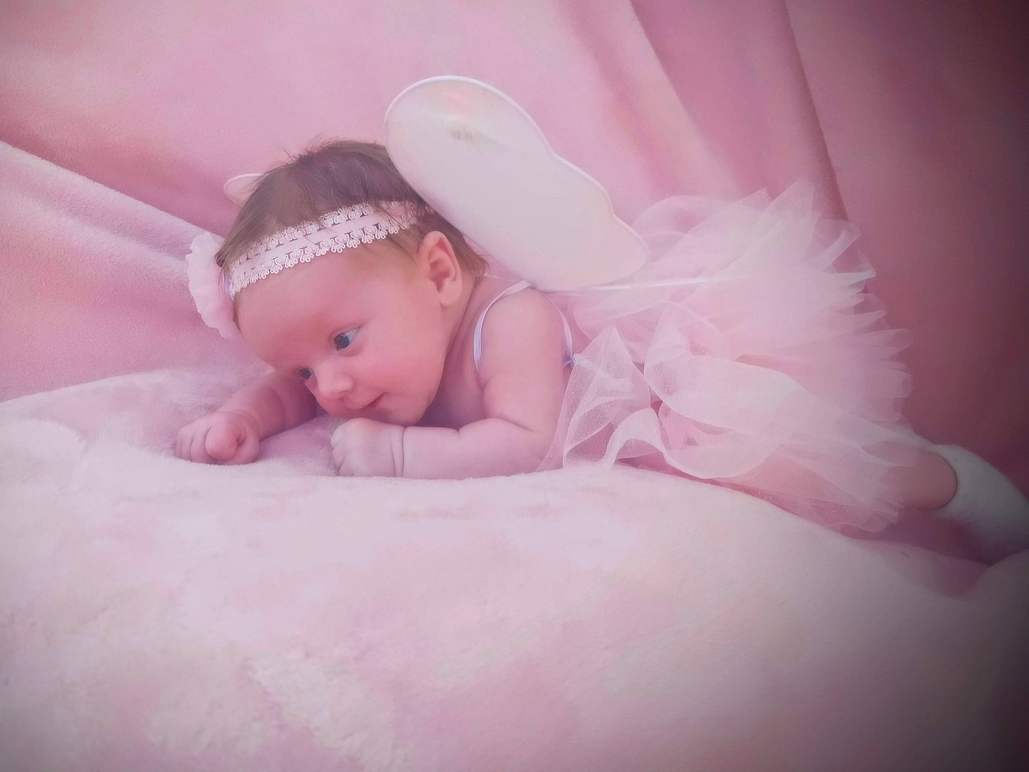 Melanie is registered to the contest to win money with this photo: baby, baby_sleeping, baby_toddler_clothing, child, comfort, dress, eye, fashion_accessory, flash_photography, flooring, hair_accessory, happy, headband, headgear, headpiece, headwear, linens, lip, magenta, person