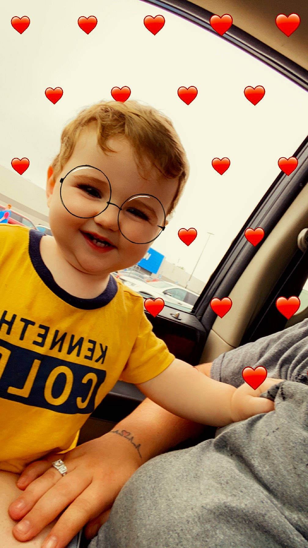 Colton is registered to the contest to win money with this photo: arm, automotive_design, chair, child, cool, eyewear, finger, fun, gesture, glasses, hand, happy, joy, leisure, motor_vehicle, person, shirt, smile, t_shirt, vehicle