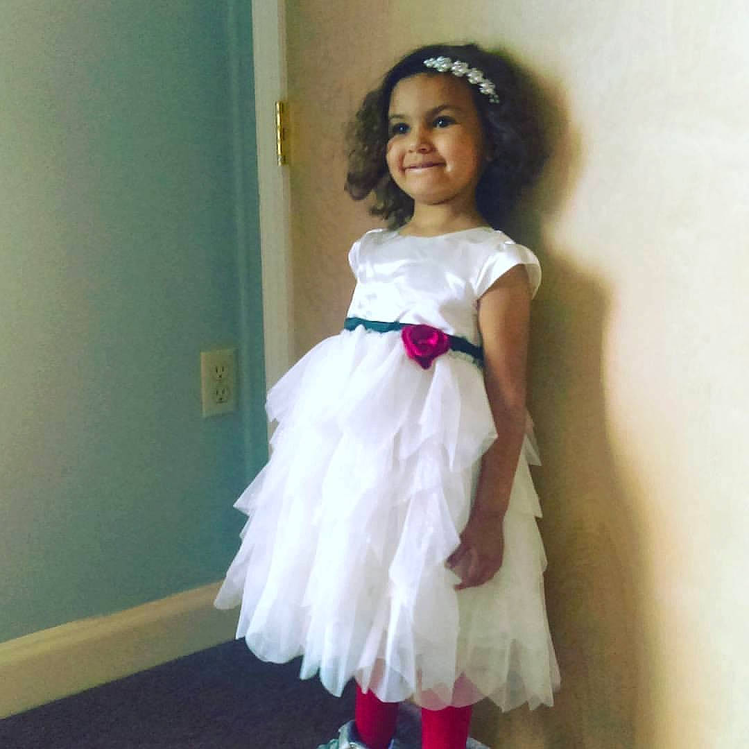 Arianna is registered to the contest to win money with this photo: baby_toddler_clothing, bridal_accessory, bridal_clothing, bridal_party_dress, day_dress, dress, embellishment, event, fashion_design, formal_wear, gown, hair_accessory, happy, iris, joy, one_piece_garment, person, shoulder, sleeve, smile