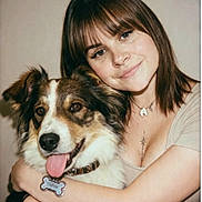 Ava participe au concours pour gagner de l'argent avec cette photo : dog, person, woman, portrait, smiling, happy, hugging, pet, companion, brown_hair, long_hair, bangs, blue_eyes, tongue, collar, dog_tag, indoor, close_up, casual_clothing, tattoo