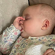 Theia is registered to the contest to win money with this photo: baby, sleeping, thumb_sucking, onesie, floral_pattern, cushion, infant, peaceful, face, hand, cozy, resting, cute, soft, child, portrait, indoors, relaxing, newborn, comfort