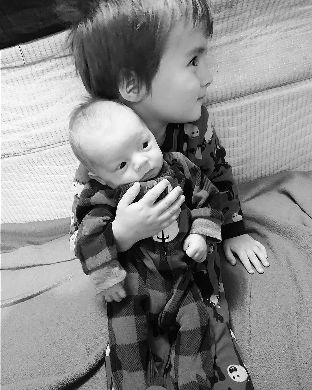 Benji is registered to the contest to win money with this photo: black_and_white, child, gesture, hug, interaction, monochrome, person, photograph, photography, sibling, style, toddler