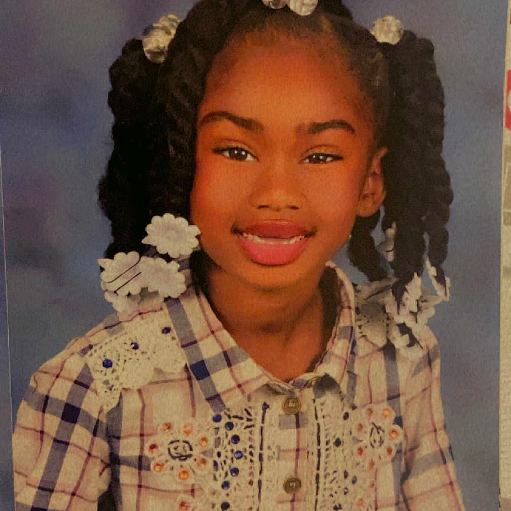Aniya joined the competition — help win amazing prizes! beads, braided_hair, buttoned_shirt, child, clothing, cute, embroidery, face, fashion, girl, hairstyle, happy, lace, person, photography, plaid_shirt, portrait, smiling, studio_background, youth