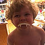 Ryan joined the competition — help win amazing prizes! child, vampire_teeth, kitchen, curly_hair, shirtless, playful, indoors, cabinet, countertop, bottle, window, decoration, smile, face, person, appliance, light, hair, home, fun