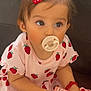 Gioia a rejoint le concours — aidez-le/la à gagner de superbes lots ! accessory, baby, bottle, child, clothing, couch, curious, cute, dress, hair_clip, holding, indoors, pacifier, person, pink, red, sitting, soft_lighting, strawberry, toddler