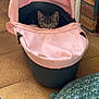 kitten, cat, baby_carrier, pink, indoor, floor, tiles, cushion, curious, pet, small, animal, domestic, tabby, feline, cozy, hidden, peeking, ears, eyes