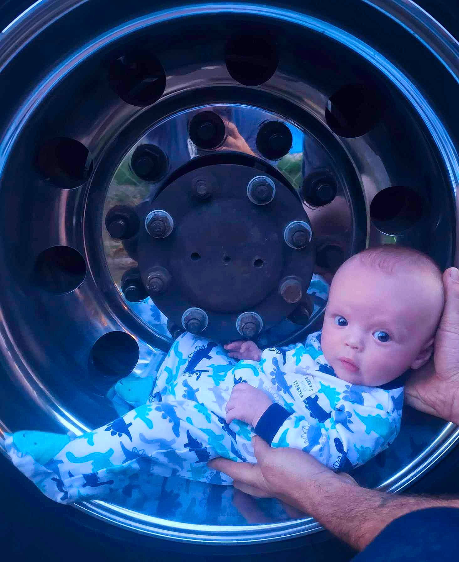 Kodie is registered to the contest to win money with this photo: alloy_wheel, automotive_design, automotive_lighting, automotive_tire, automotive_wheel_system, baby_toddler_clothing, blue, circle, electric_blue, flash_photography, gas, hubcap, light, person, rim, synthetic_rubber, tire, tire_care, toddler, tread