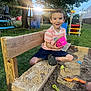 bench, boy, child, daytime, grass, happy, outdoor, plastic_toy, play, playground, recreation, sand, sandbox, shorts, smiling, sunlight, toy, tree, tshirt, wood