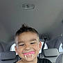 Ronan joined the competition — help win amazing prizes! black_shirt, boy, car_interior, casual, child, face, fake_teeth, fun, happy, head, indoors, person, playful, portrait, seat, seatbelt, short_hair, smile, vampire_teeth, window