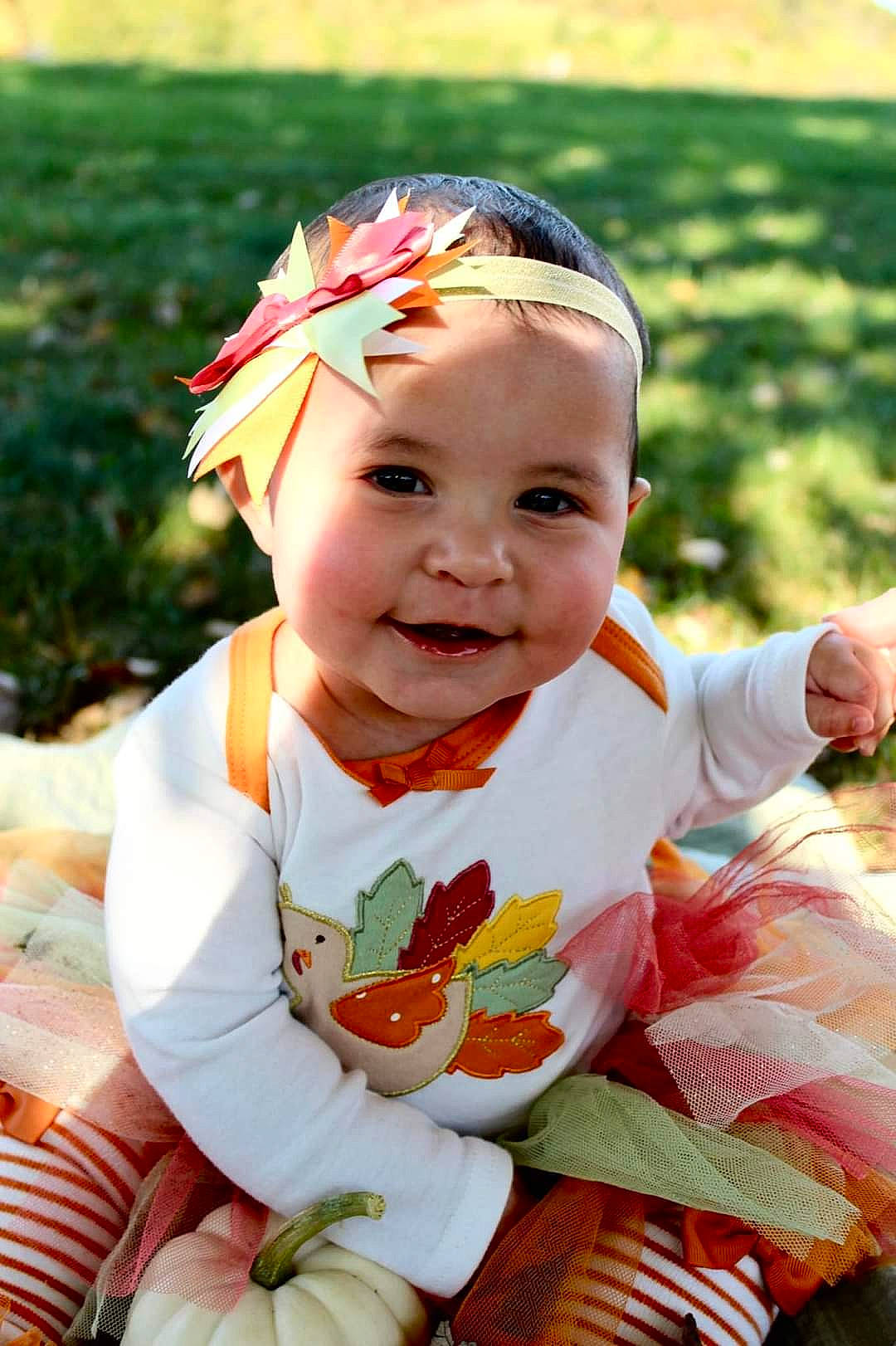 Kyrah is registered to the contest to win money with this photo: baby, baby_toddler_clothing, child, event, eye, fashion_accessory, fun, grass, hair_accessory, happy, hat, headband, headpiece, headwear, joy, leisure, people_in_nature, person, plant, recreation