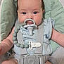 Millie is registered to the contest to win money with this photo: baby, infant, pacifier, seat, straps, blue_clothing, child, cute, indoor, person, closeup, toddler, sitting, looking_at_camera, padded_seat, safety_harness, soft_texture, skin, young_child, adorable