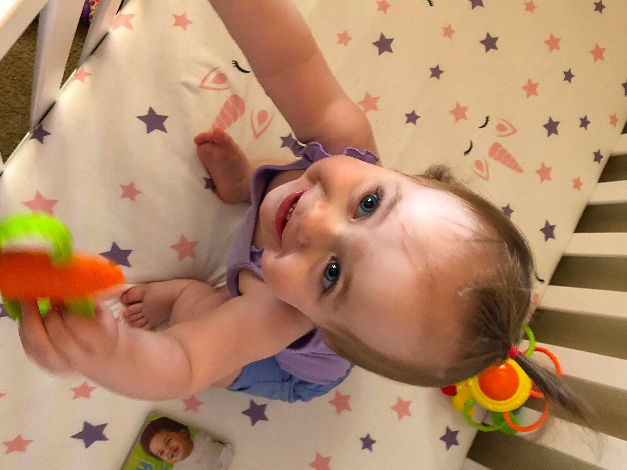 Lilly is registered to the contest to win money with this photo: baby, baby_playing_with_toys, baby_products, baby_toddler_clothing, cheek, child, eyelash, fun, happy, joy, nose, orange, person, petal, pink, room, skin, textile, toddler, toy