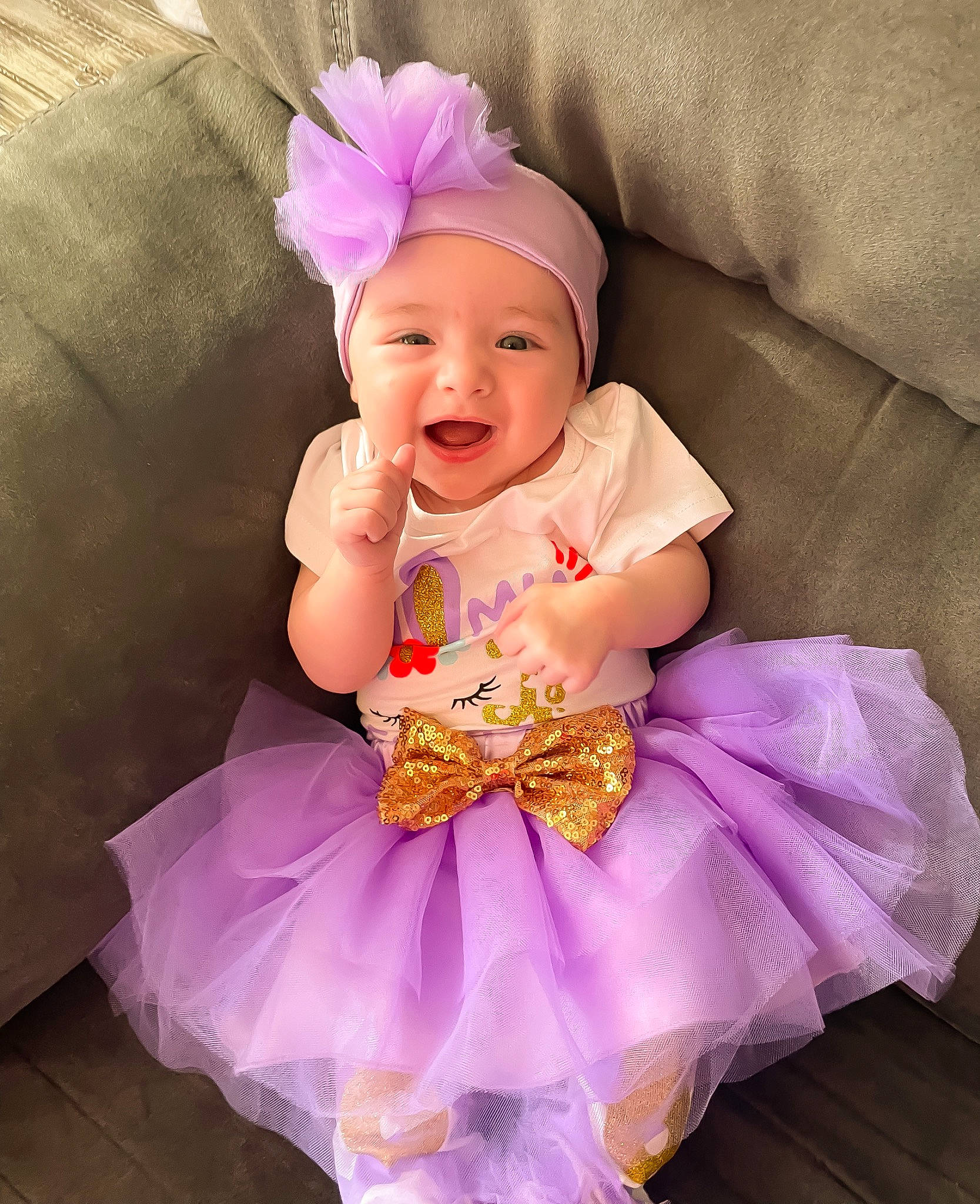 Layla joined the competition — help win amazing prizes! baby, baby_toddler_clothing, ballet_tutu, costume_hat, dress, fun, hair_accessory, happy, headpiece, headwear, magenta, mythical_creature, party_supply, person, petal, pink, purple, ruffle, smile, toddler