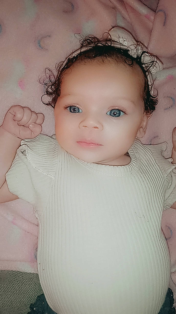 Makenna is registered to the contest to win money with this photo: baby, baby_toddler_clothing, cheek, eye, eyebrow, eyelash, flash_photography, gesture, happy, headgear, human_body, iris, lip, neck, nose, person, pink, shoulder, skin, sleeve