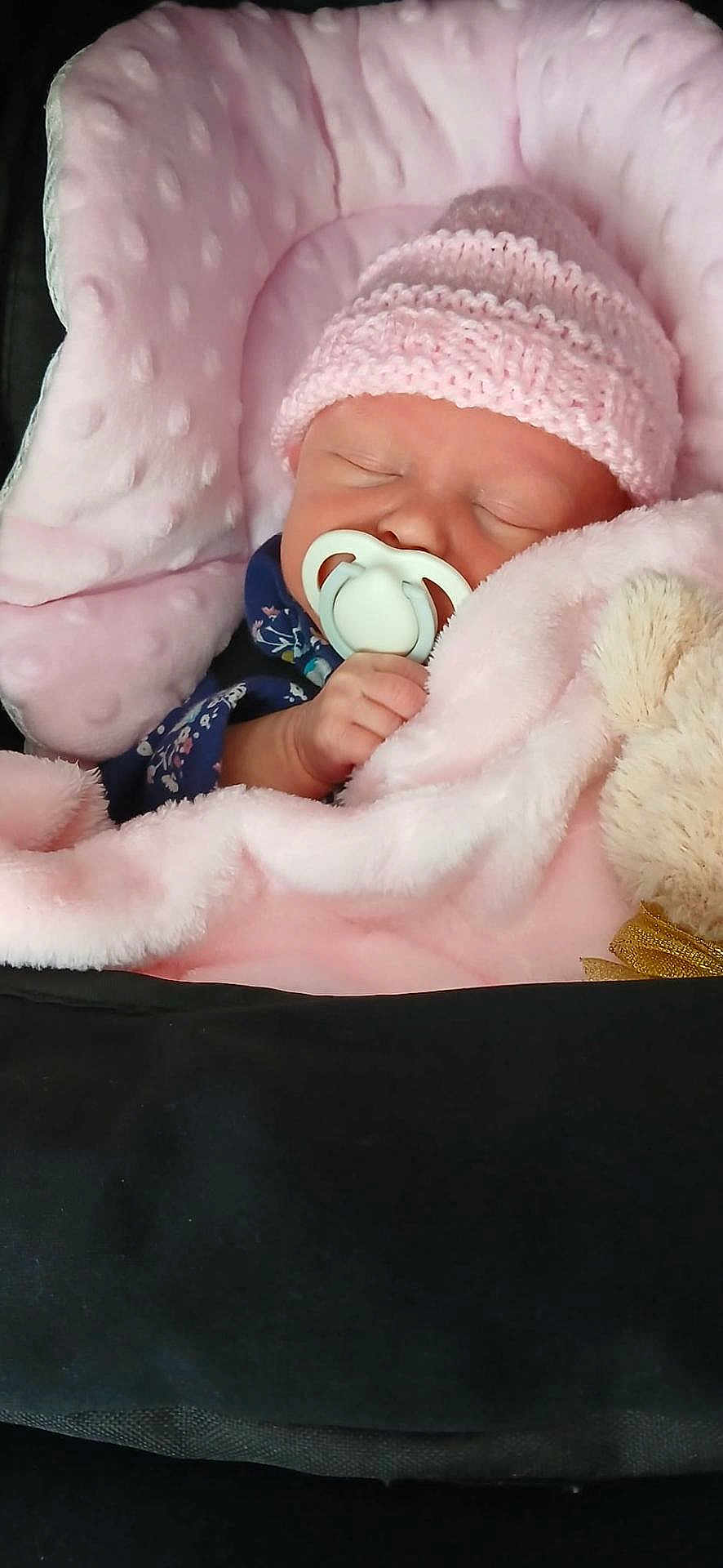 Amara-Leigh joined the competition — help win amazing prizes! baby, sleeping, pacifier, blanket, pink, hat, knitted, plush_toy, infant, cute, cozy, child, soft, resting, closeup, portrait, wrapped, hand, peaceful, indoors