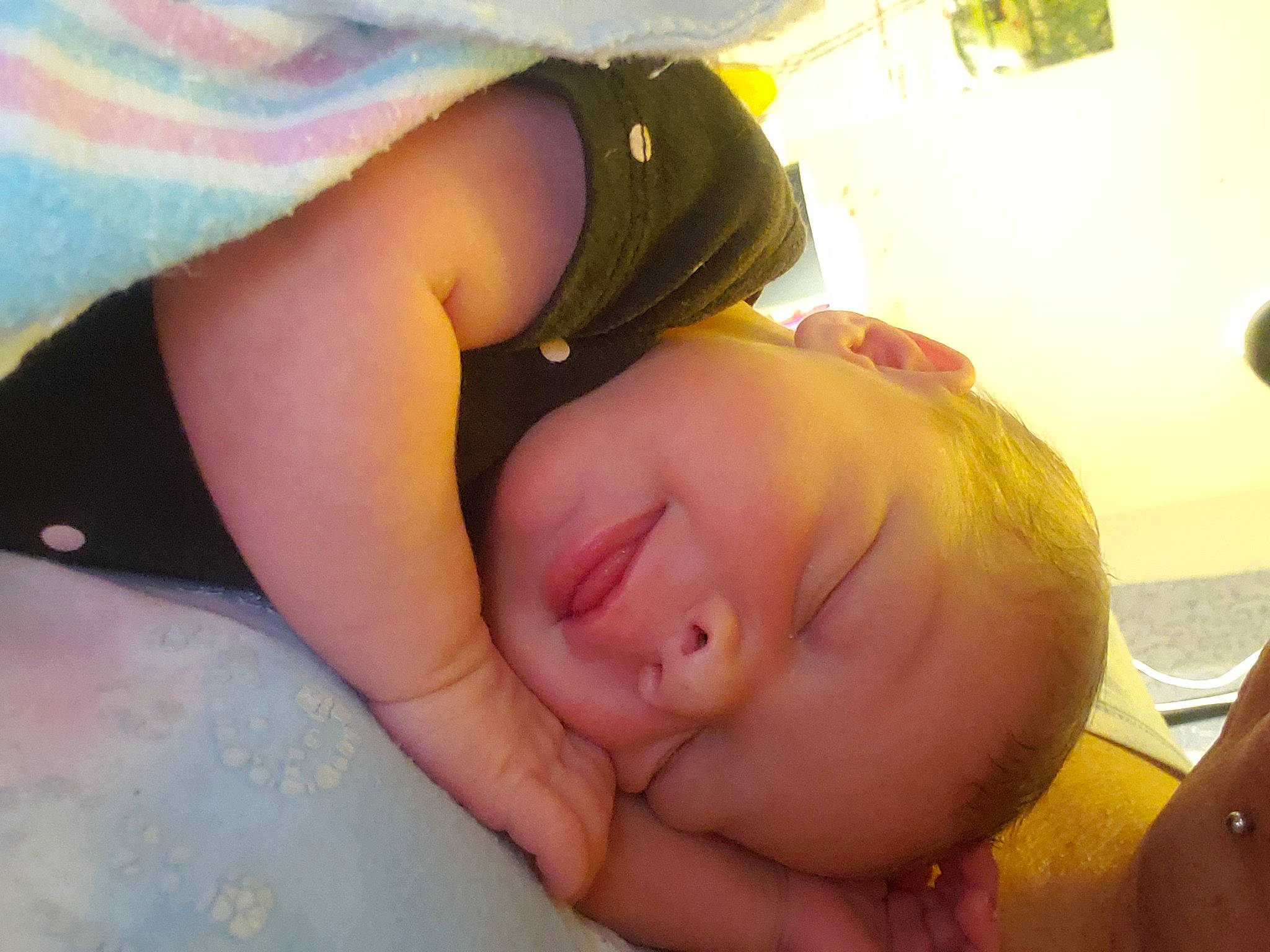 Trinity is registered to the contest to win money with this photo: arm, baby, cheek, chest, comfort, eye, eyebrow, eyelash, gesture, hand, happy, human_body, lip, mouth, muscle, neck, nose, person, plant, skin