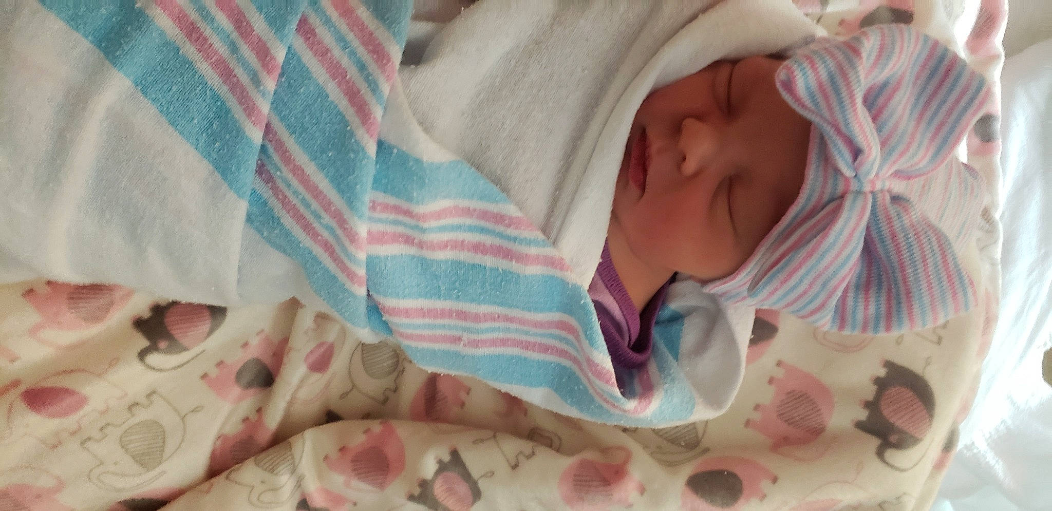 Trinity is registered to the contest to win money with this photo: baby, baby_sleeping, baby_toddler_clothing, bedding, carmine, child, comfort, flesh, headwear, linens, nail, pattern, peach, person, pink, plaid, room, skin, sleeve, textile