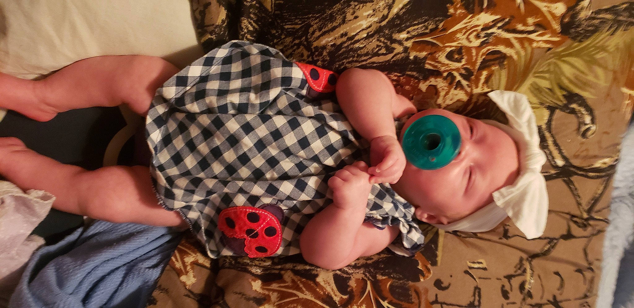 Trinity joined the competition — help win amazing prizes! baby, baby_toddler_clothing, child, comfort, finger, headgear, human, mouth, nail, orange, pattern, people, person, plaid, skin, sleeve, sunglasses, tartan, textile, toy