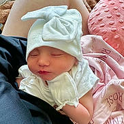 Raelynne joined the competition — help win amazing prizes! baby, newborn, sleeping, hat, mittens, white_clothing, blanket, pink_blanket, soft_texture, closeup, infant, peaceful, resting, cute, cozy, person, skin, face, small_child, indoors