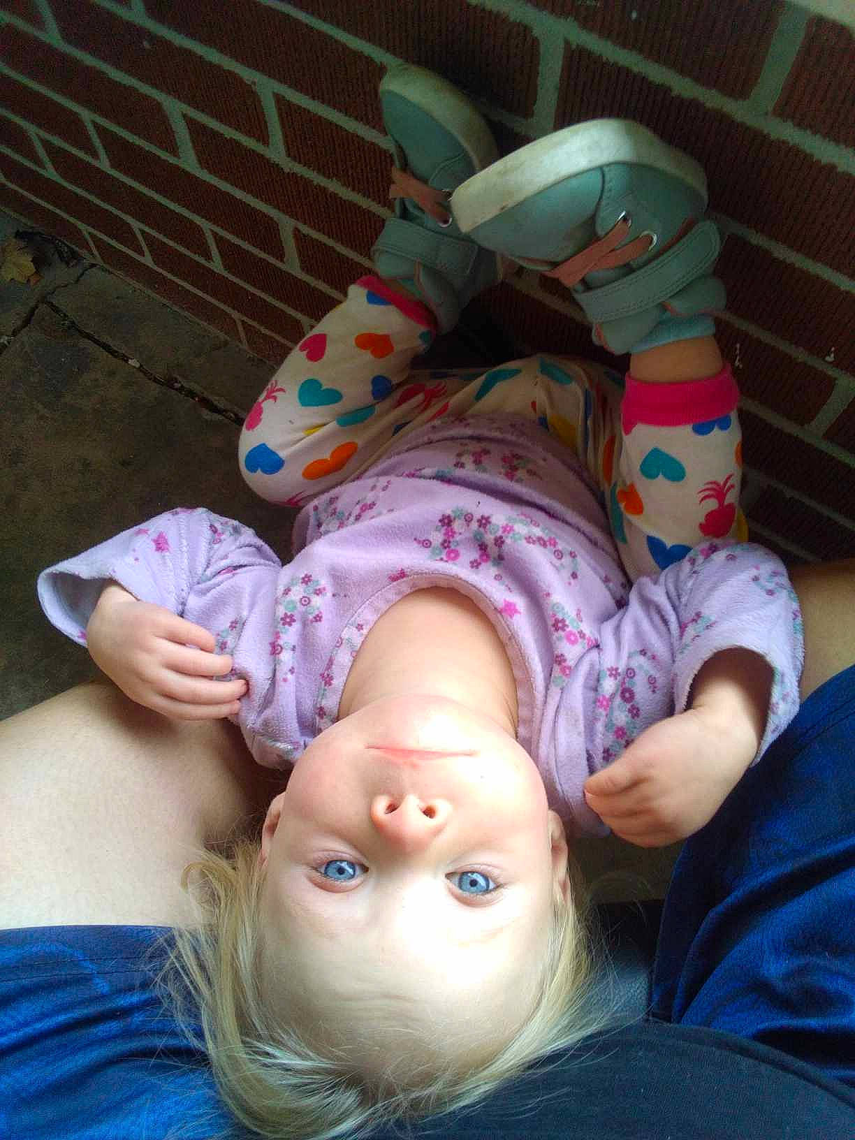 Carly joined the competition — help win amazing prizes! baby, baby_toddler_clothing, cheek, child, comfort, finger, foot, fun, grass, happy, human, human_leg, mammal, mouth, person, pink, sitting, skin, thigh, toddler