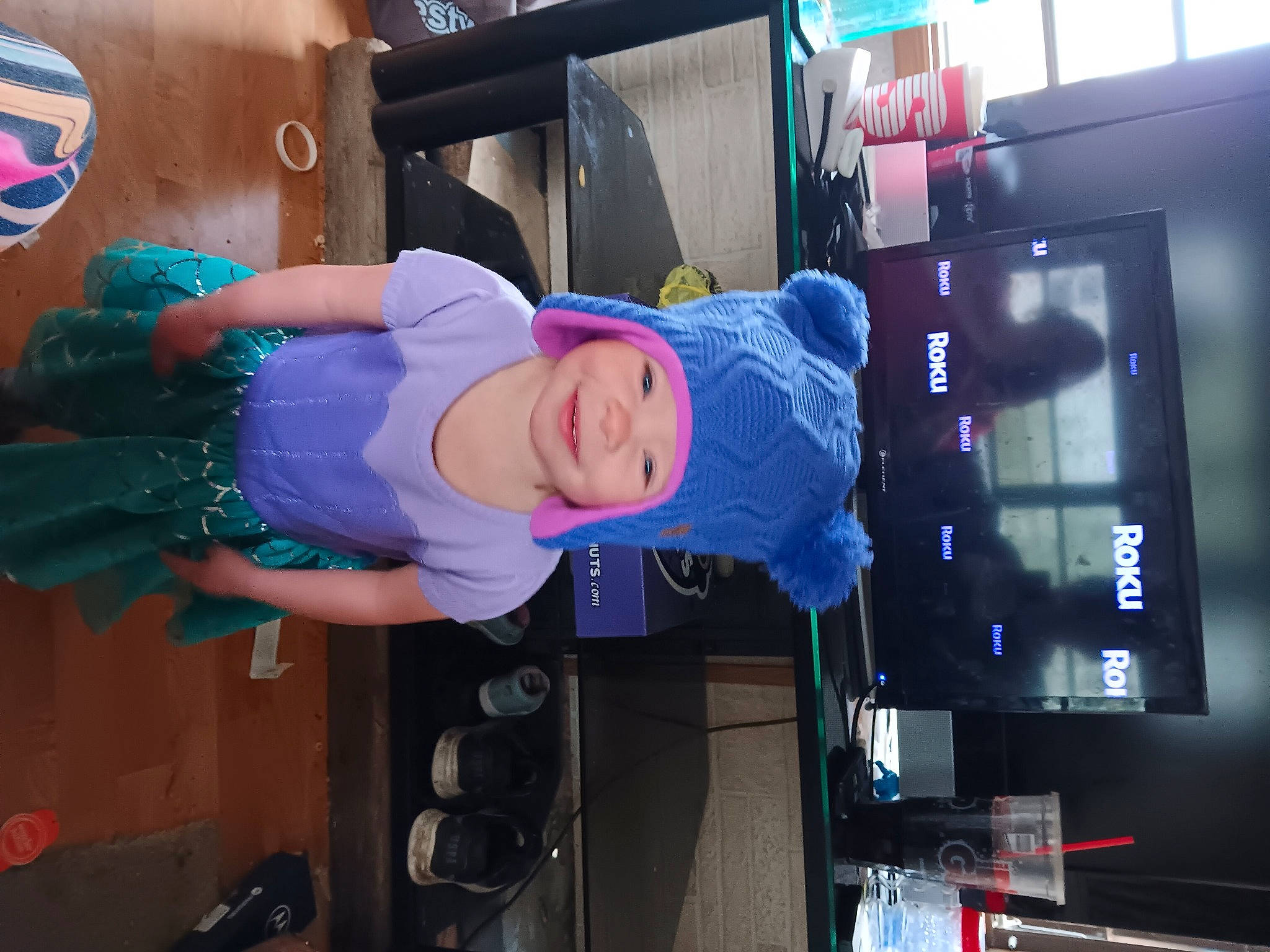 Carly is registered to the contest to win money with this photo: baby, baby_toddler_clothing, child, electric_blue, fun, hat, headwear, joy, machine, magenta, person, purple, room, smile, sun_hat, t_shirt, toddler