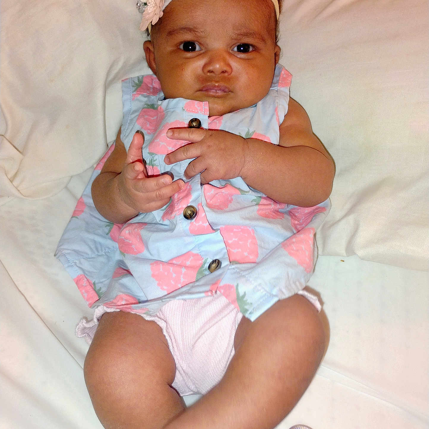 Gabriella joined the competition — help win amazing prizes! baby, button, child, cute, dress, expression, eyes, fabric, face, floral, hand, headband, indoors, infant, legs, lying_down, mouth, nose, skin, white_background