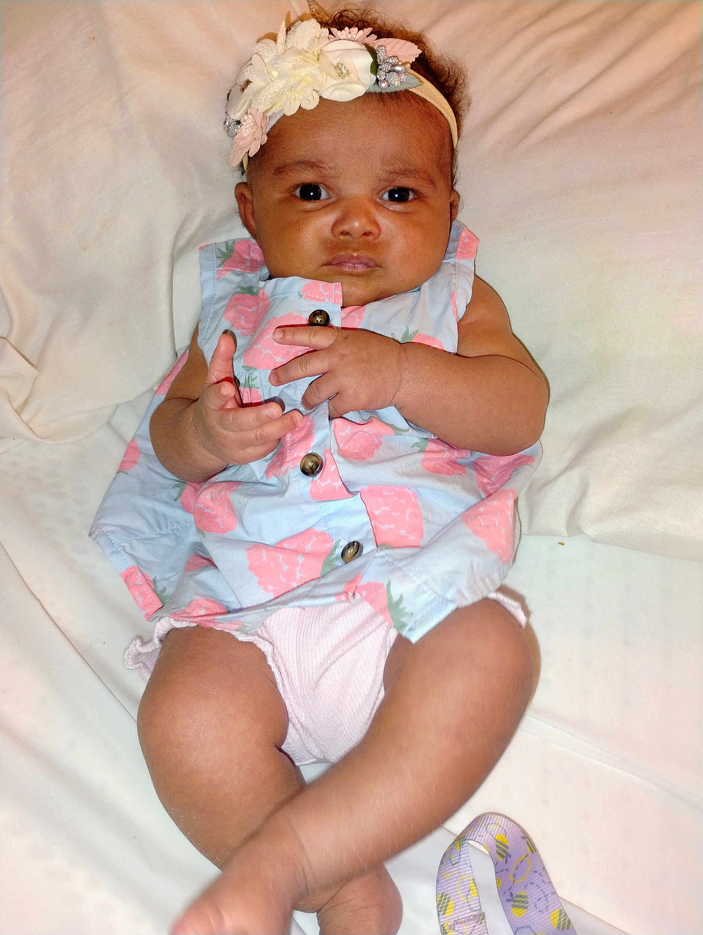 Gabriella joined the competition — help win amazing prizes! baby, infant, child, headband, dress, floral, hand, legs, skin, face, eyes, nose, mouth, white_background, fabric, button, expression, lying_down, cute, indoors