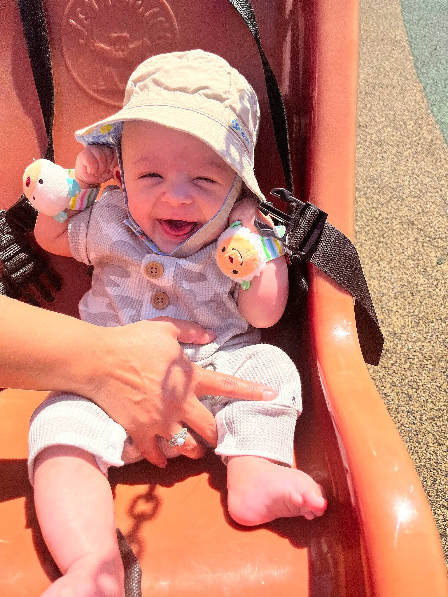 Baylor is registered to the contest to win money with this photo: baby, baby_toddler_clothing, baseball_cap, cap, comfort, finger, fun, hand, happy, headwear, human_body, lap, leisure, mouth, person, photograph, pink, skin, smile, thigh