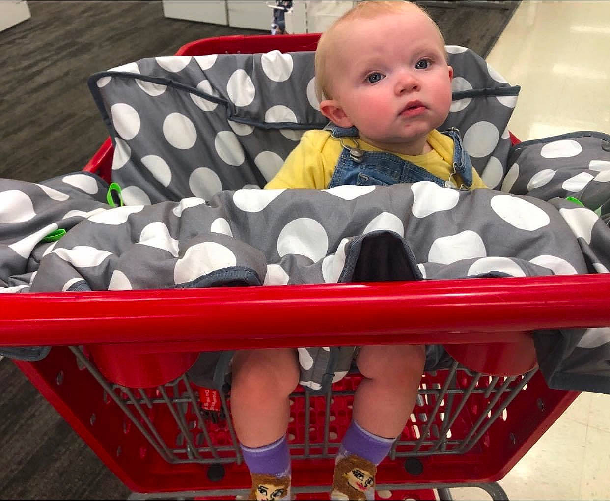 Elle is registered to the contest to win money with this photo: baby, baby_safety, baby_toddler_clothing, black, child, comfort, eye, head, linens, outdoor_furniture, pattern, people, person, photograph, product, rectangle, shorts, sleeve, thigh, toddler