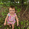 child, toddler, smiling, portrait, outdoors, forest, woodland, nature, greenery, trees, leaves, plants, barefoot, floral_outfit, dress, standing, face, hair, happy, exploration