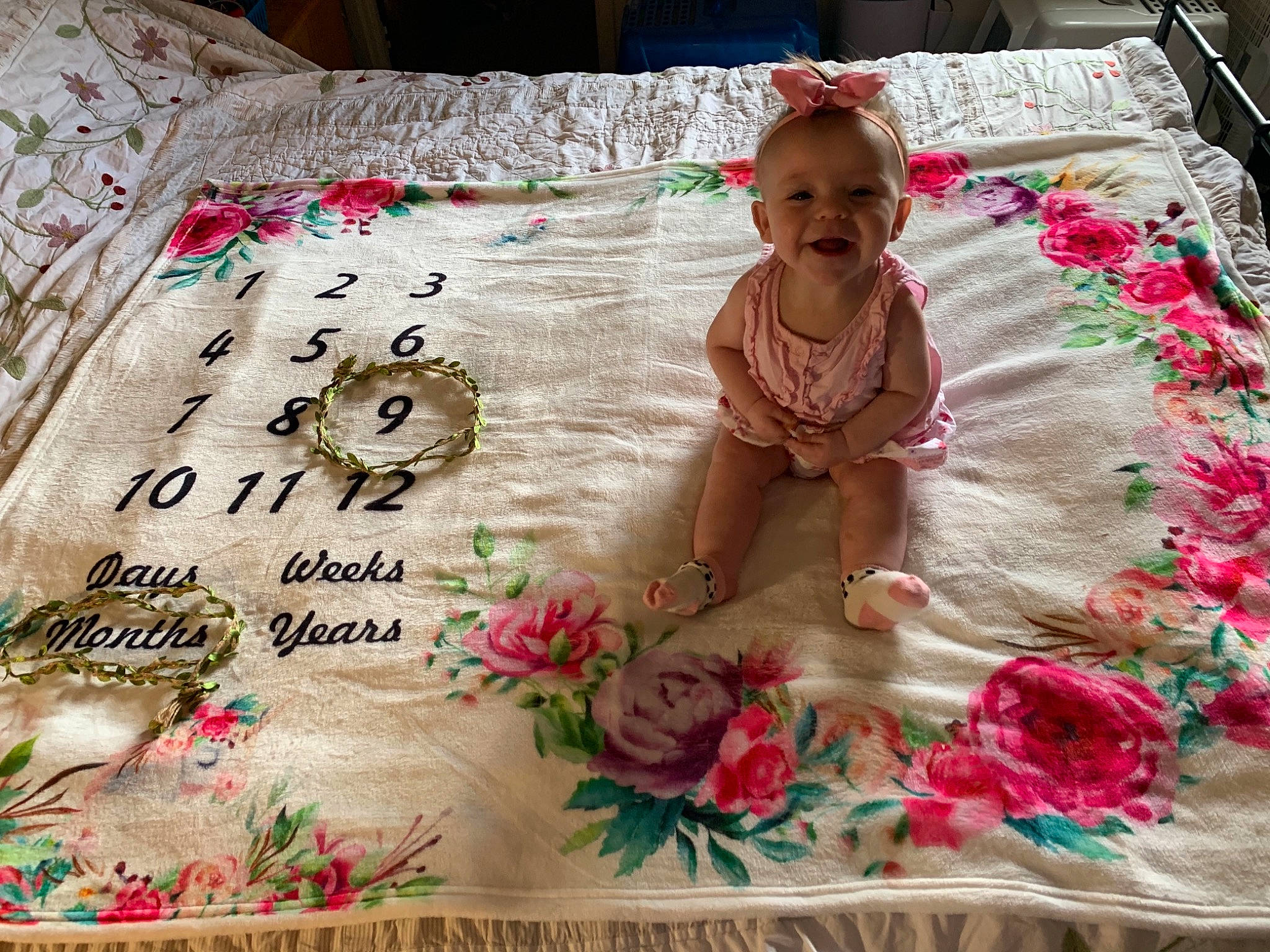 Kaylynn is registered to the contest to win money with this photo: baby, baby_toddler_clothing, bedding, child, craft, creative_arts, event, flooring, linens, magenta, needlework, pattern, person, petal, pink, product, rectangle, smile, tablecloth, textile