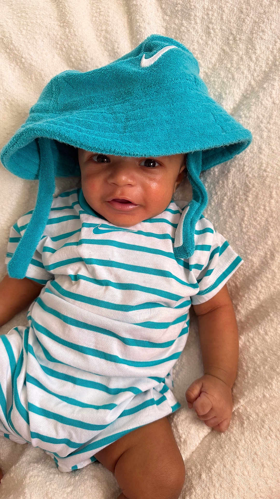 Jru joined the competition — help win amazing prizes! baby, blanket, child, closeup, clothing, cute, fabric, hand, hat, indoors, infant, laying, person, portrait, skin, smiling, soft, striped, teal, white