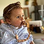 baby, pacifier, curly_hair, headband, shirt, heart_pattern, indoor, portrait, child, clothing, cute, person, young_child, face, expression, beads, soft_light, focus, closeup, infant