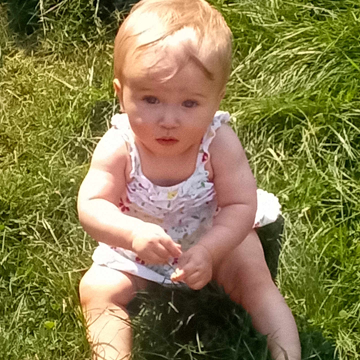 Alaeleea joined the competition — help win amazing prizes! baby, barefoot, child, curious, dress, face, grass, greenery, hair, hands, infant, legs, nature, outdoor, person, sitting, skin, summer, sunlight, young