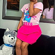 Linda is registered to the contest to win money with this photo: child, girl, pink_skirt, tshirt, stuffed_animal, husky, couch, mirror, barefoot, blowing_kiss, indoor, portrait, reflection, bow, toy, smiling, hairband, home, cute, decor