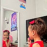 child, girl, red_dress, mirror, reflection, bow, hair, dresser, television, wall_poster, room, indoor, furniture, curiosity, portrait, person, home, lighting, face, expression