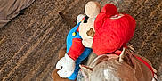 Genie joined the competition — help win amazing prizes! dog, pitbull, plush_toy, mario, carpet, indoor, blue_eyes, red_harness, looking_up, stuffed_animal, floor, clothes, fabric, toy, pet, animal, cute, playful, home, cozy