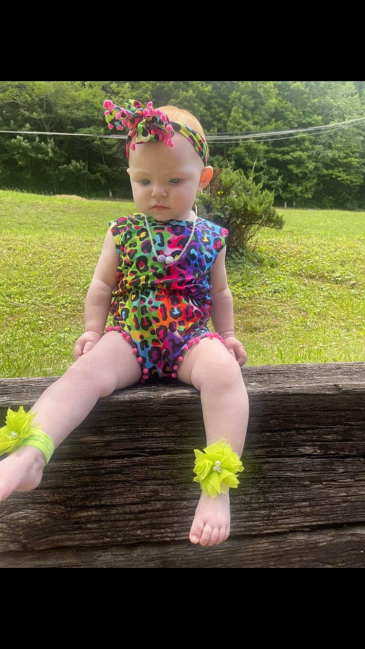 Emma joined the competition — help win amazing prizes! baby_toddler_clothing, barefoot, child, electric_blue, fashion_accessory, foot, fun, grass, happy, headband, human_leg, leisure, magenta, pattern, people_in_nature, person, pink, plant, sleeve, thigh