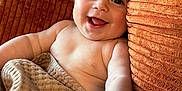 Hayes joined the competition — help win amazing prizes! baby, smiling, blanket, couch, texture, happy, infant, skin, face, tongue, arm, hand, seated, indoors, comfort, cozy, expression, cute, child, relaxing