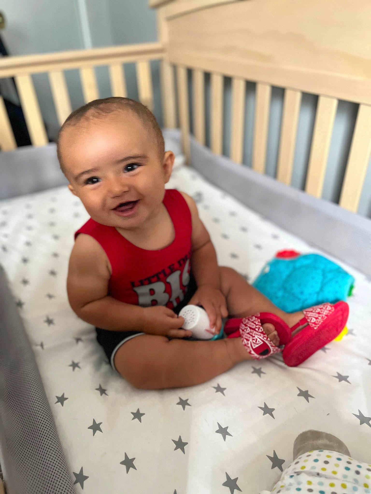 Desmond is registered to the contest to win money with this photo: baby, baby_toddler_clothing, black, blue, comfort, facial_expression, finger, floor, flooring, fun, happy, knee, person, shorts, skin, smile, sock, thigh, toddler, white
