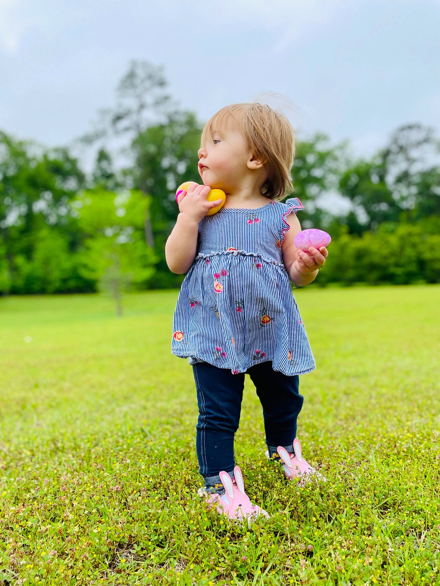 Arya is registered to the contest to win money with this photo: baby_toddler_clothing, child, fun, gesture, grass, grass_family, grassland, green, happy, lawn, leisure, meadow, natural_environment, pattern, people_in_nature, person, plant, playing_with_kids, sky, toddler