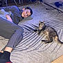 Stars is registered to the contest to win money with this photo: boy, carpet, casual_clothing, cat, chair, child, cozy, floor, furniture, globe, happy, home, indoor, lying_down, pattern, pet, relaxing, smile, tabby_cat, wooden_floor